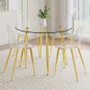 A modern minimalist style round transparent tempered glass table with gold metal legs